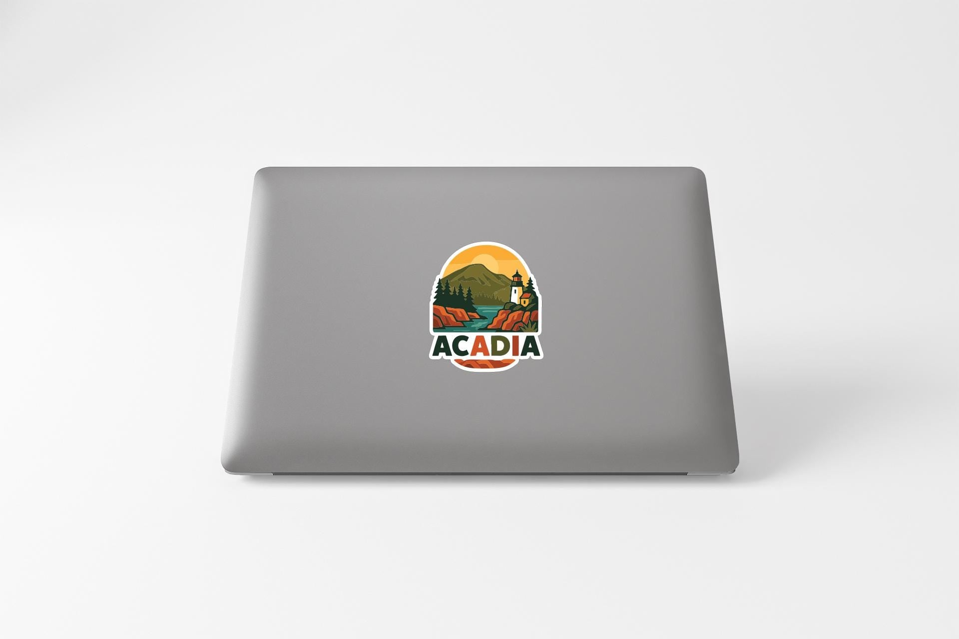 a sticker with the word "ACADIA" on the back of a laptop.