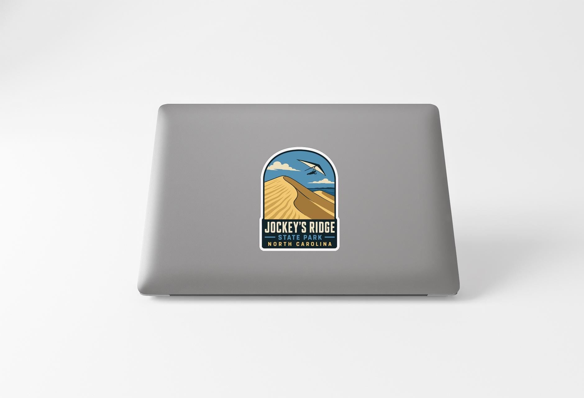 a sticker on the back of a laptop that says "JACKY'S RIDE THE PARKLANE NORTH CAROLINA".