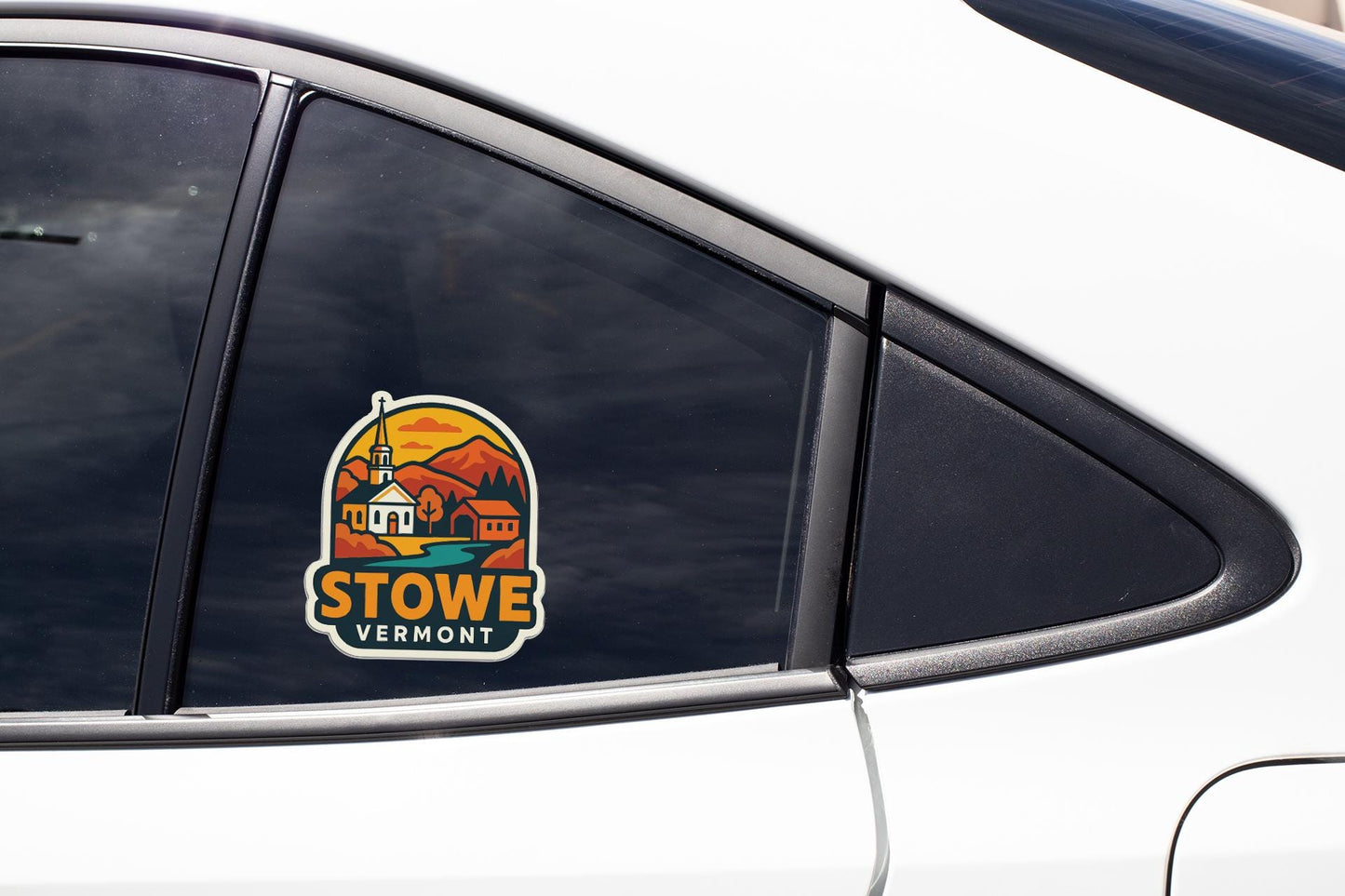 A Stow, Vermont-themed decal is visible on the side of a car, featuring a church and mountains in a colorful, stylized design.