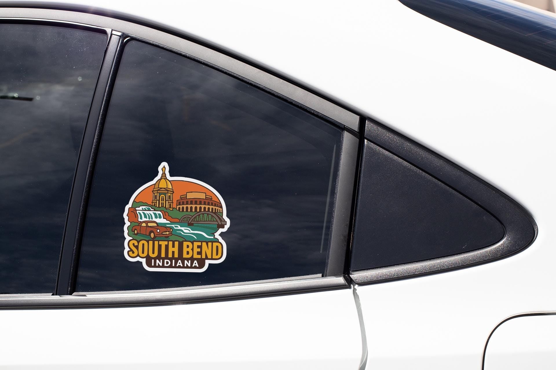 A sticker on the side of a car window, depicting a cityscape with a prominent building and the text "SOUTH BEND, INDIANA".