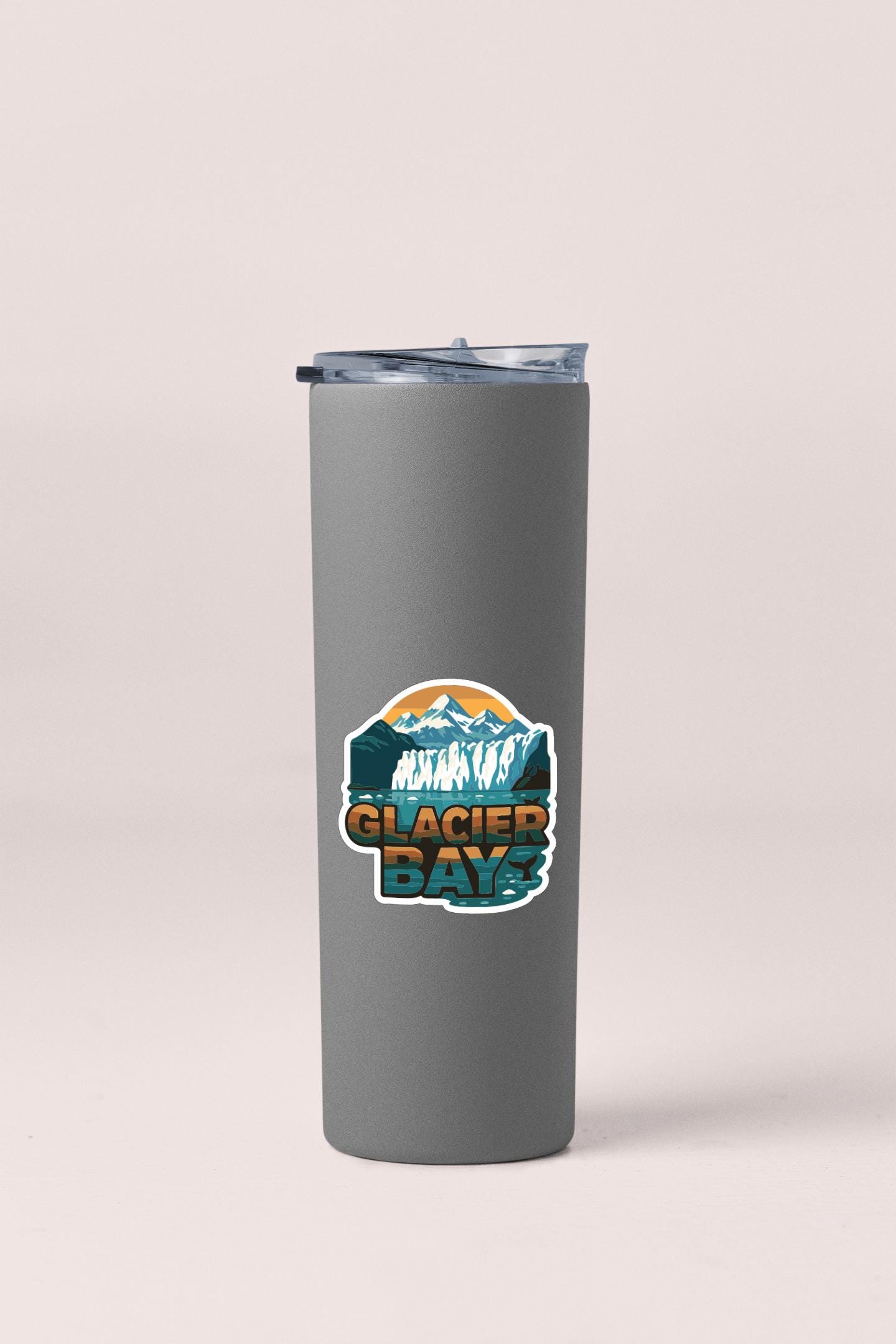 A gray insulated tumbler with a sticker that says "Glacier Bay".