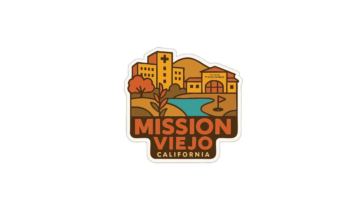a sticker or logo with a stylized illustration of a cityscape, including buildings, a river, and trees. The text "MISSION VIEJO CALIFORNIA" is prominently displayed in the center of the image.