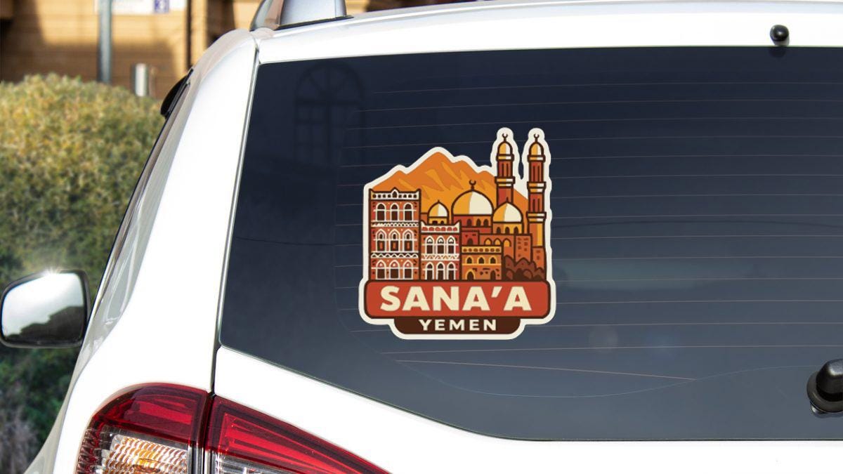 a sticker on the rear window of a car, depicting a cityscape with buildings and a mosque.