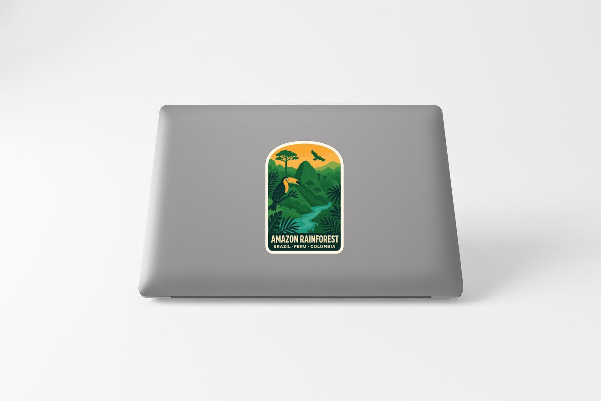 a sticker with a tropical jungle scene on a laptop.