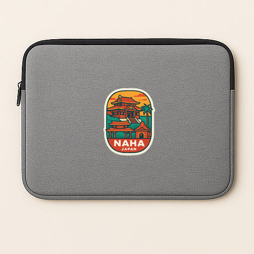 A gray laptop sleeve with a colorful sticker depicting a temple and the text "NHA JAPAN" printed on it.