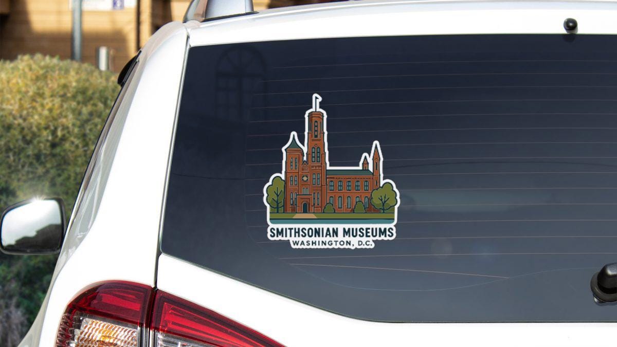 a sticker on the rear window of a vehicle that displays the text "Smithsonian Museums Washington, D.C."