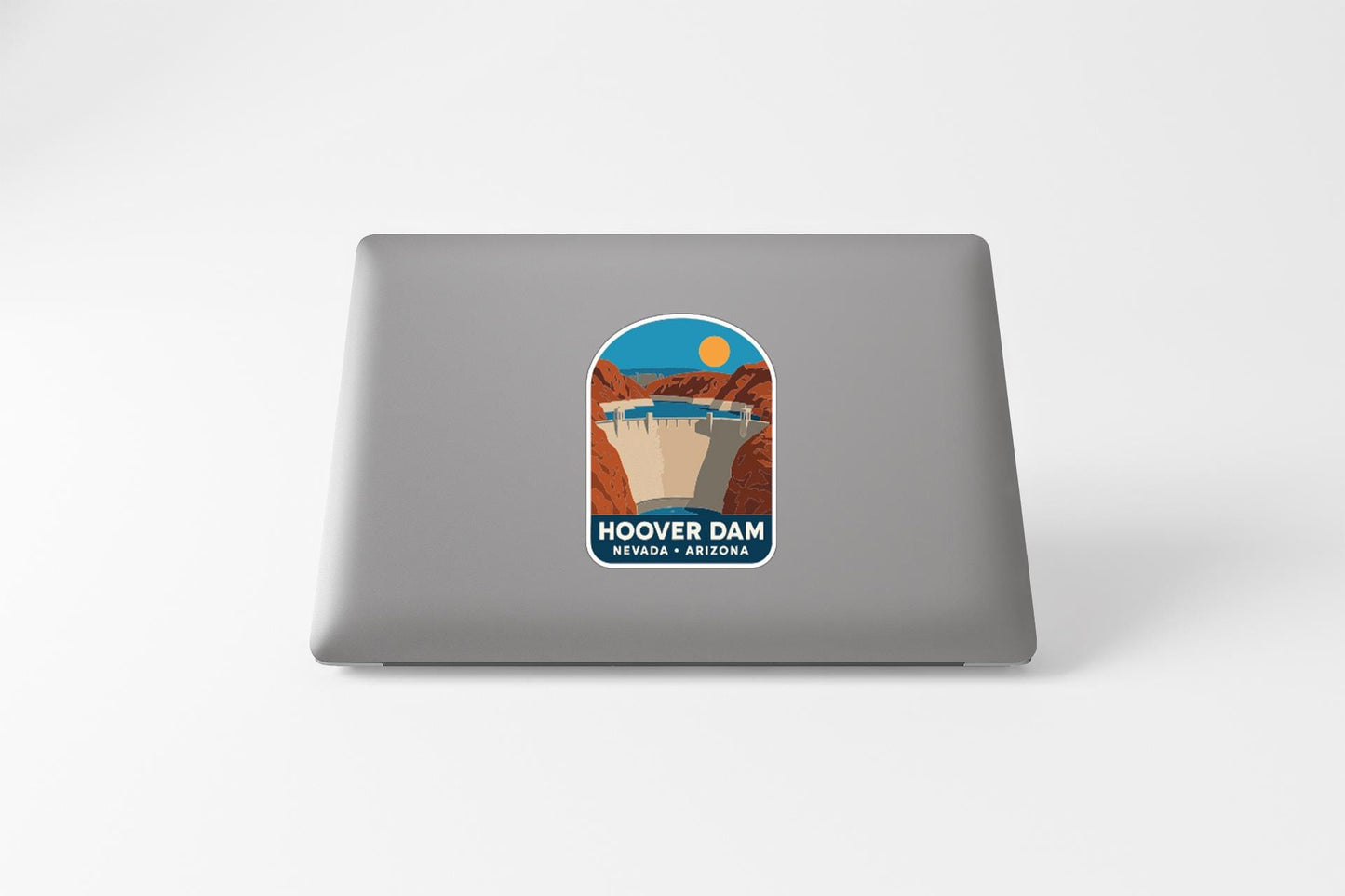 A sticker on the back of a laptop, depicting the Hoover Dam in Nevada, Arizona.