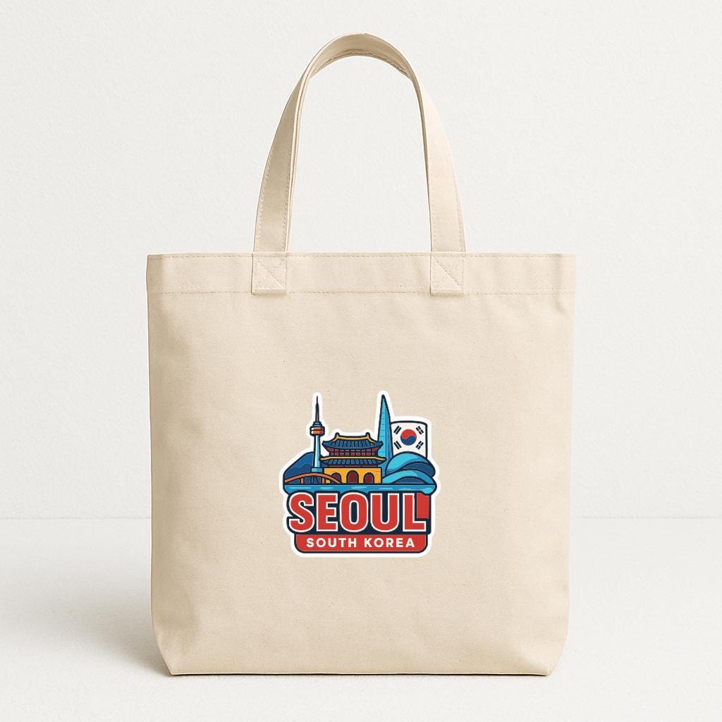 A beige tote bag with a graphic design featuring the skyline of Seoul, South Korea, including the Gyeongbokgung Palace and the Seoul Tower.
