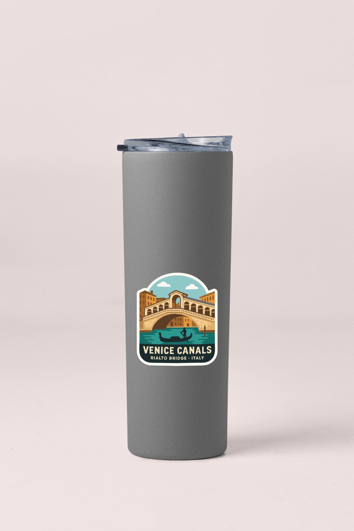 A gray insulated tumbler with a label that features an illustration of the Rialto Bridge in Venice, Italy.