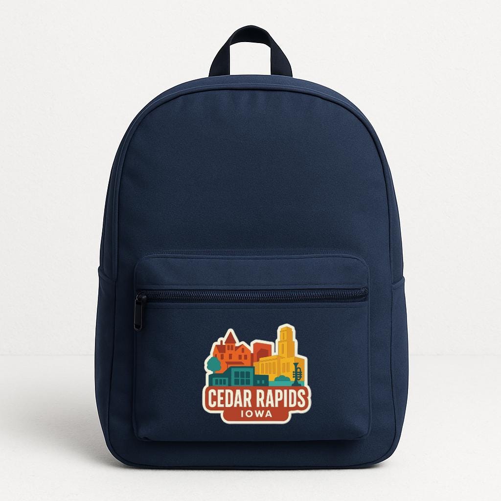 A navy blue backpack with a graphic of a city skyline and the text "Cedar Rapids, Iowa" printed on it.