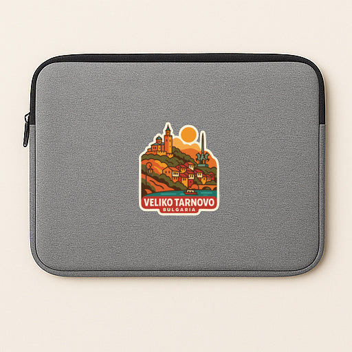 A gray laptop sleeve with a sticker depicting a scenic view of Veliko Tarnovo, a city in Bulgaria.