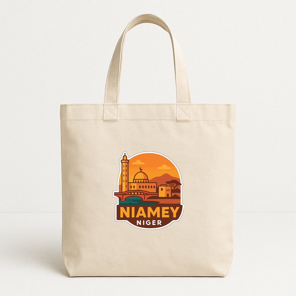 A beige tote bag with a graphic design featuring a city skyline and the text "NIAMEY NIGER" printed on it.