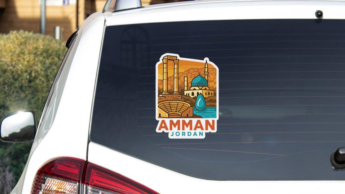 A sticker on the rear window of a car, depicting a cityscape with a mosque in the background.