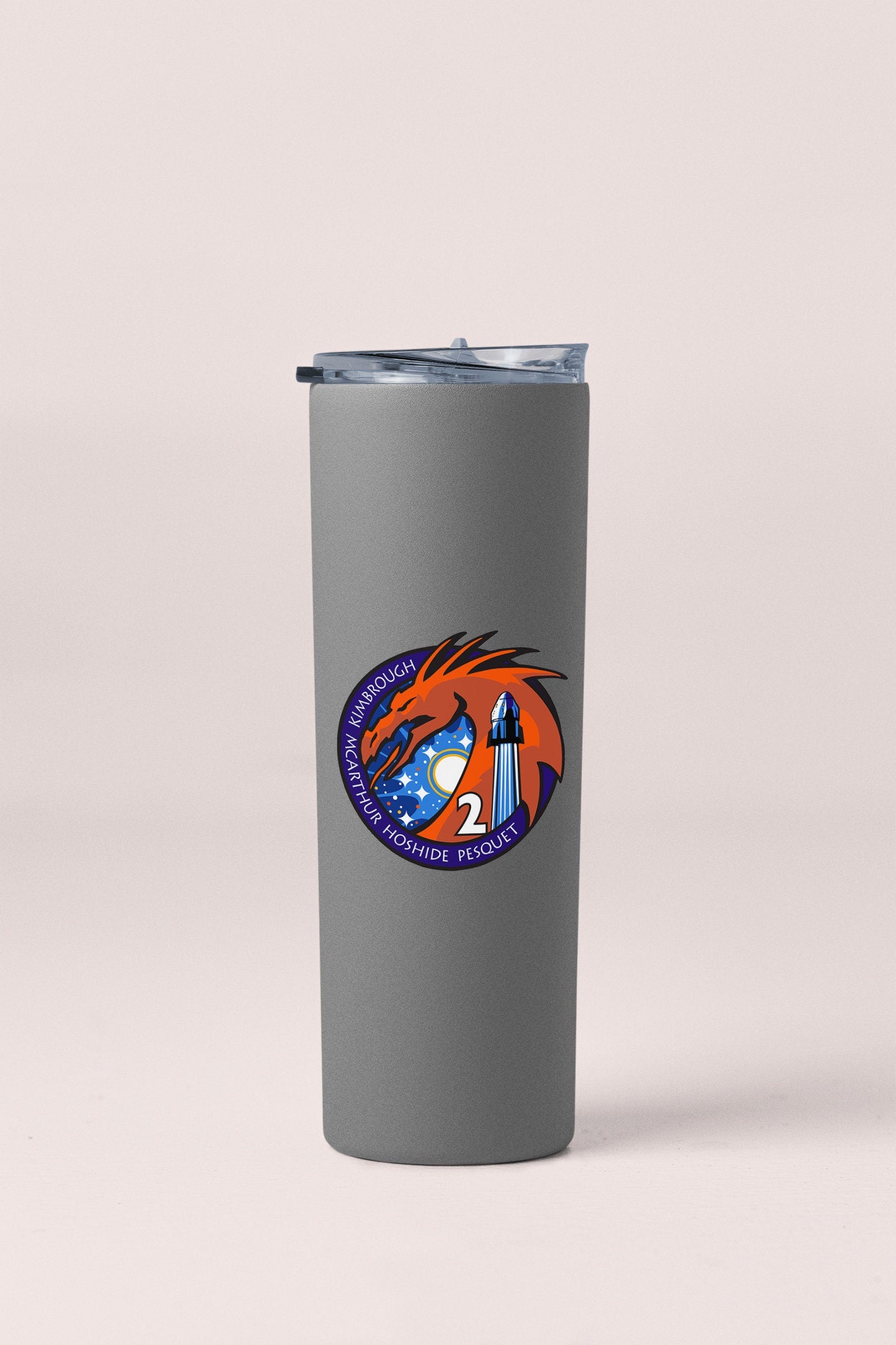 a stainless steel tumbler with a picture of a rocket ship on it