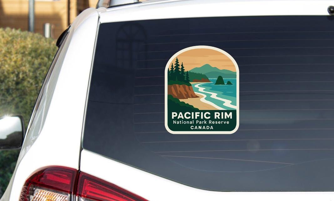 A sticker on the rear window of a vehicle that says "PACIFIC RIM National Park Reserve CANADA".