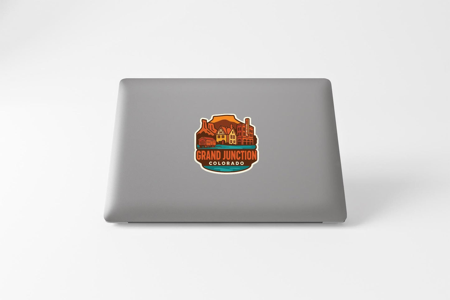 A sticker on the back of a laptop, featuring an illustration of a building and the text "GRAND JUNCTION COLORADO".