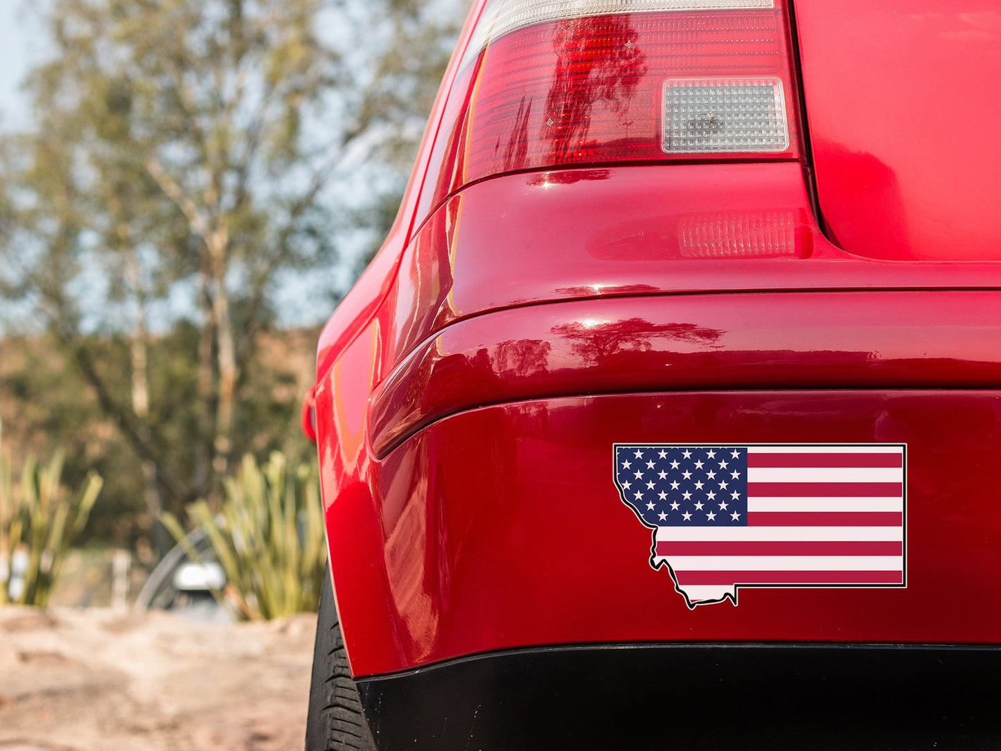 a red car with an american flag sticker on it