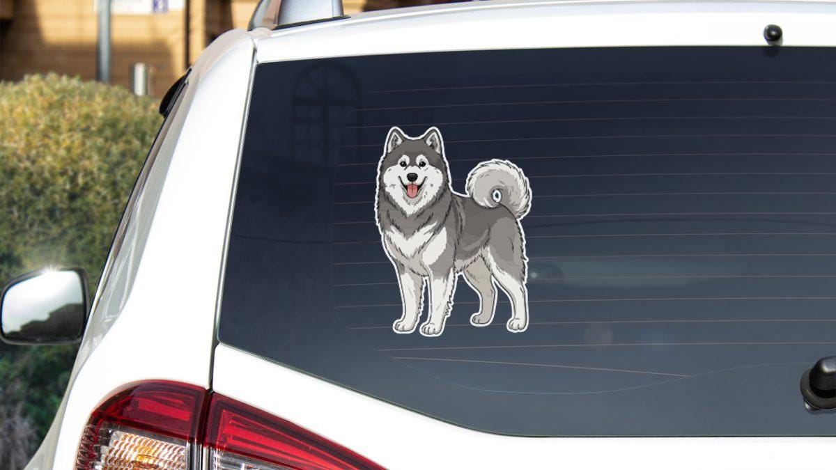 a sticker of a dog on the rear window of a car.