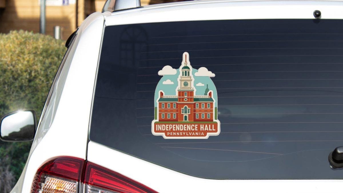 a sticker on the rear window of a vehicle, depicting Independence Hall in Pennsylvania.