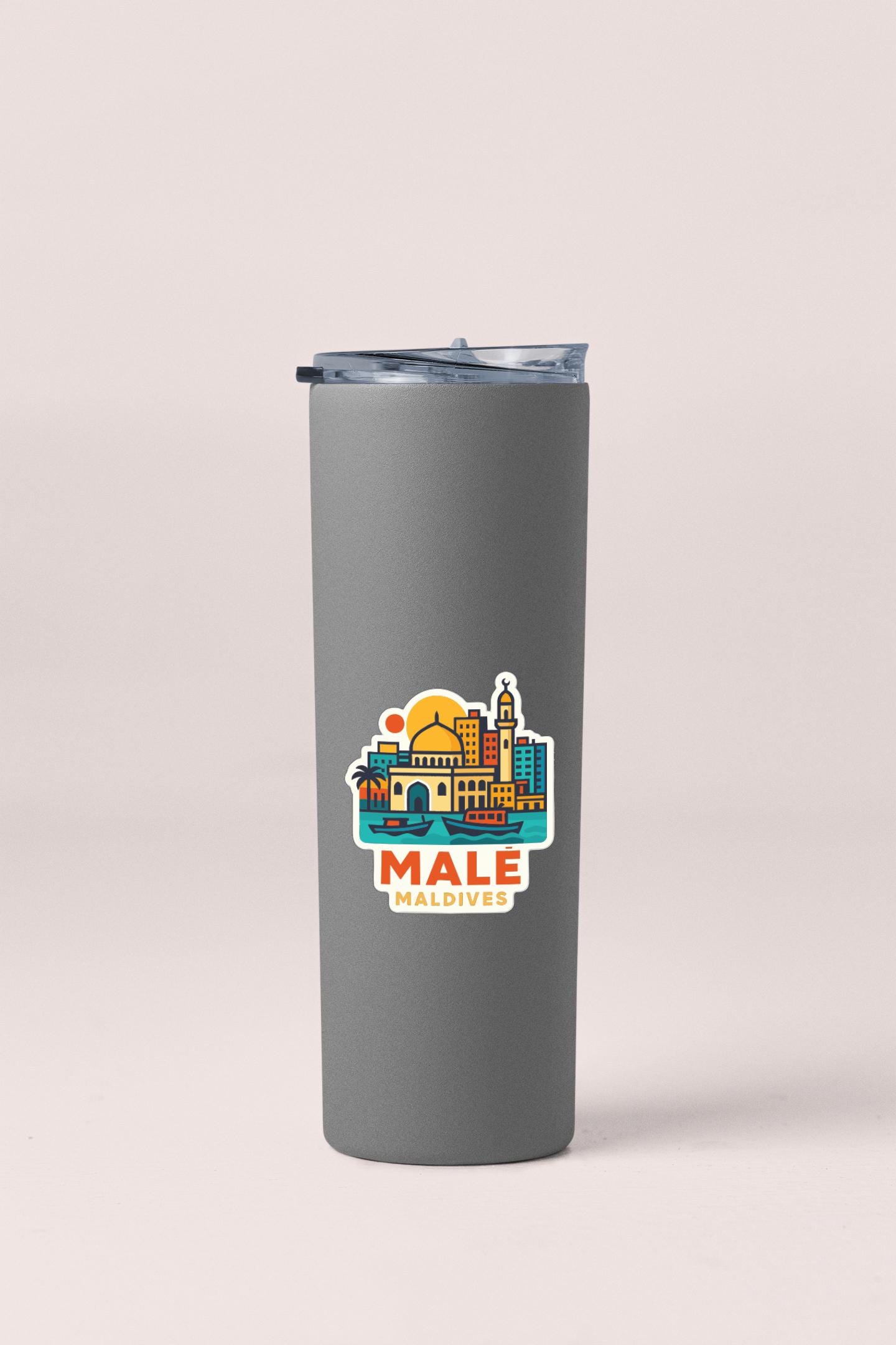 A gray insulated tumbler with a colorful graphic of the Maldives cityscape on it.