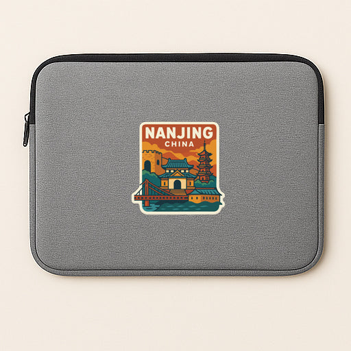 A gray laptop sleeve with a sticker depicting a cityscape and the text "Nanjing China".