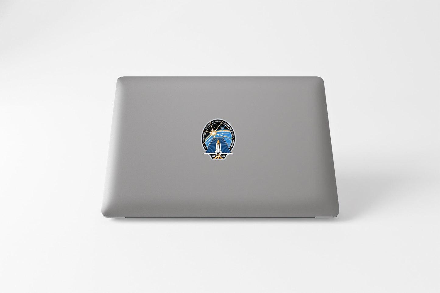 a laptop with a sticker of a bird on it
