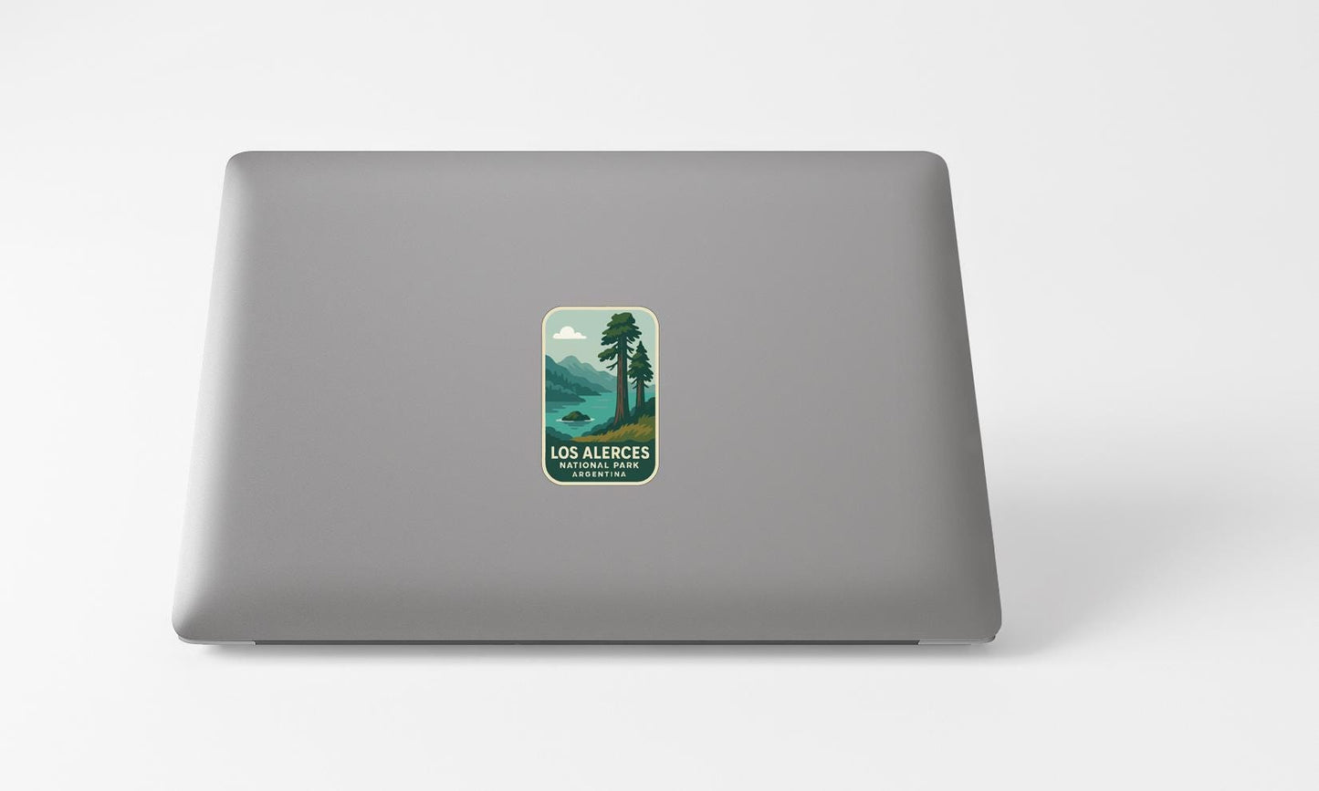 A sticker with a landscape image and text on the back of a laptop computer.