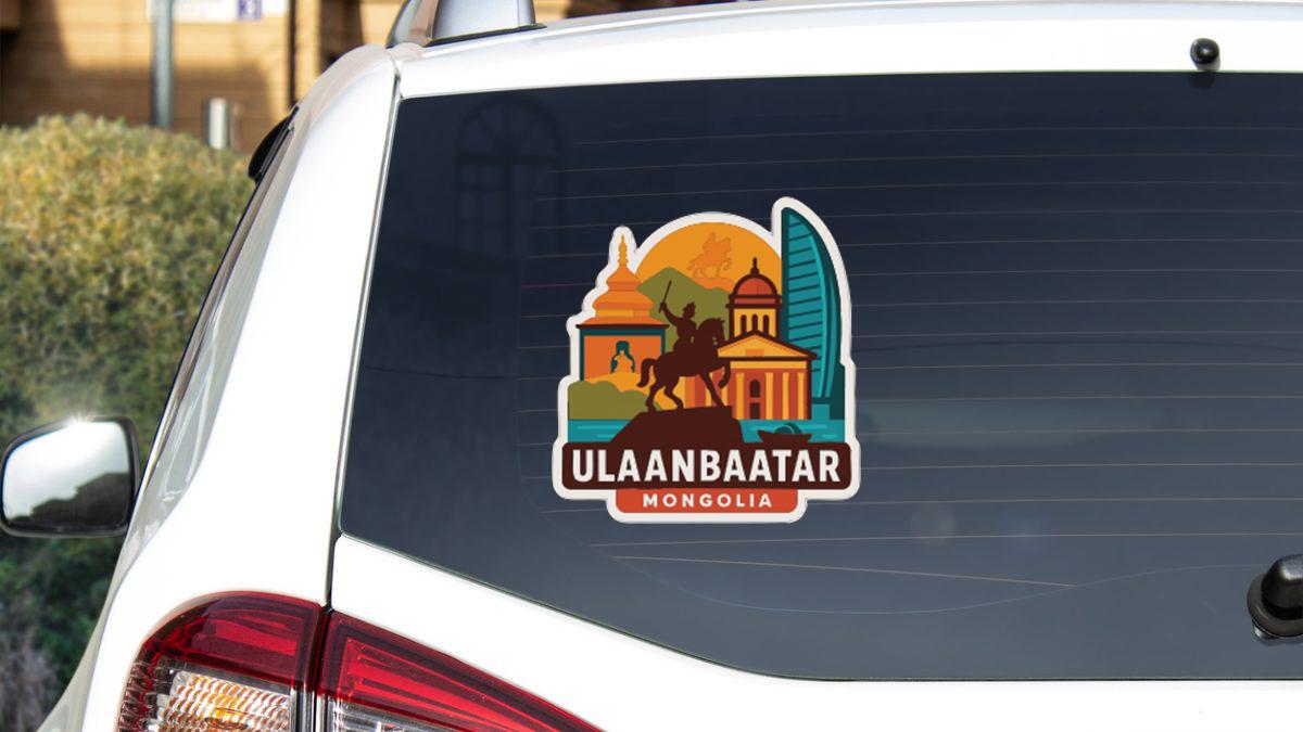 A sticker on the rear window of a car, featuring an illustration of a landmark and the text "ULAANBAATAR MONGOLIA".