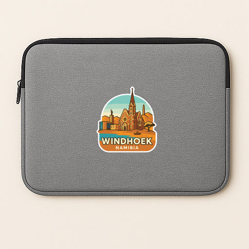 A gray laptop sleeve with a sticker depicting the Windhoek cityscape of Namibia.