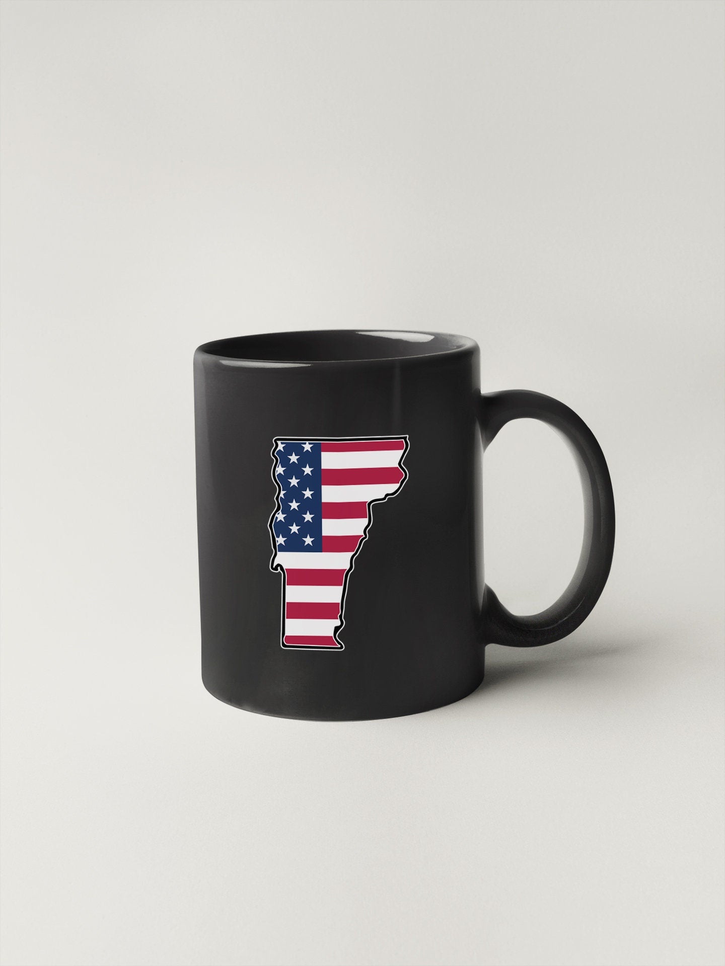 a black coffee mug with the state of minnesota painted on it