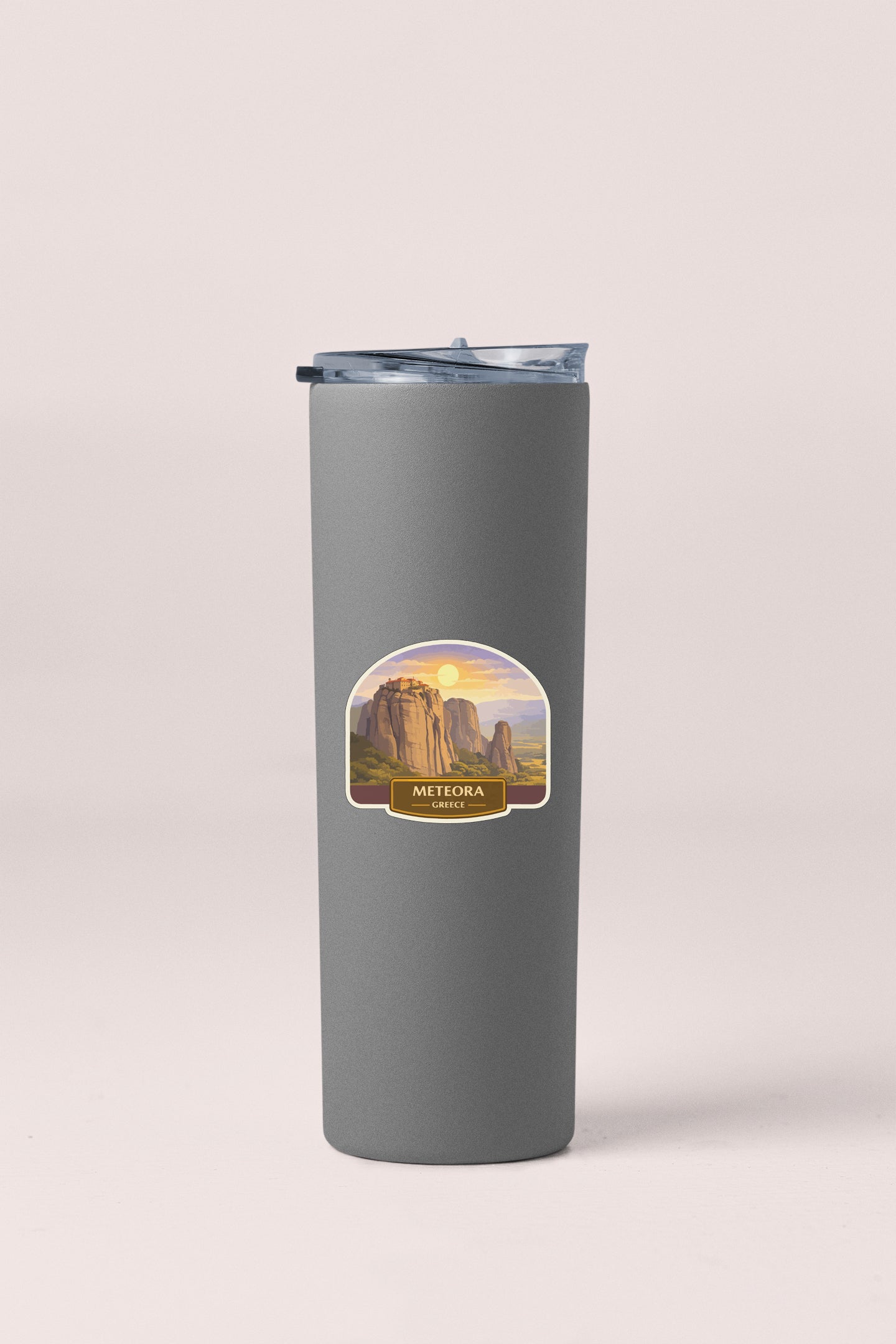 A gray insulated tumbler with a label that says "METEORA Greece".