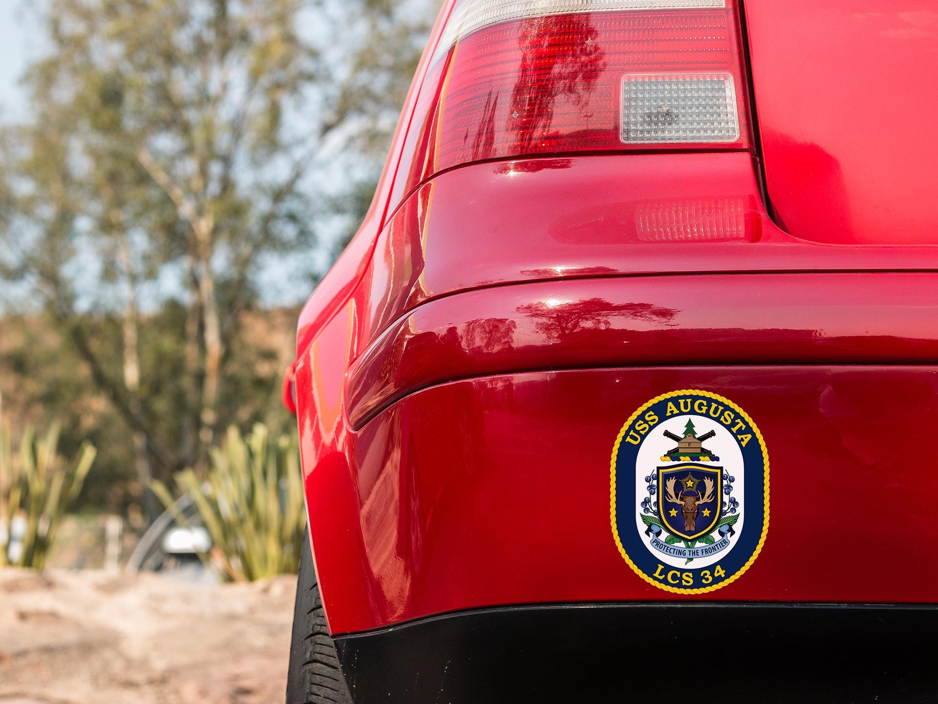 a close up of the emblem on the back of a red car