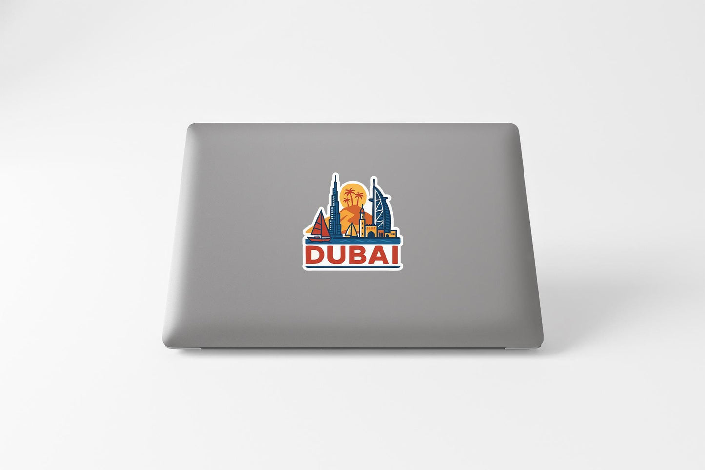 a laptop with a sticker of a city skyline