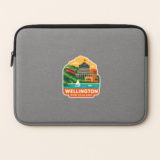 A gray laptop sleeve with a colorful sticker depicting the city of Wellington, New Zealand.