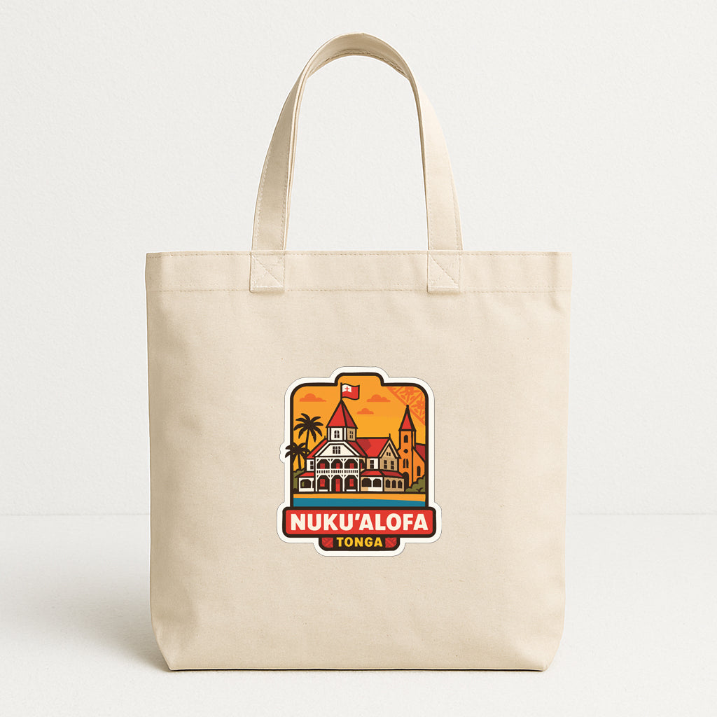 A beige tote bag with a graphic design featuring a tropical island and a building, along with the text "NUKU ALOFA TONGA".