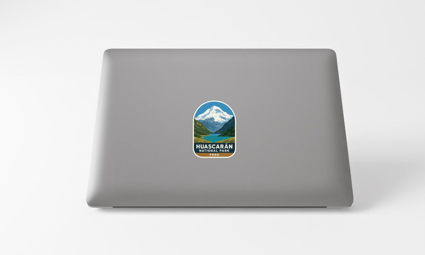 A sticker on the back of a laptop displaying the Huascar National Park logo.