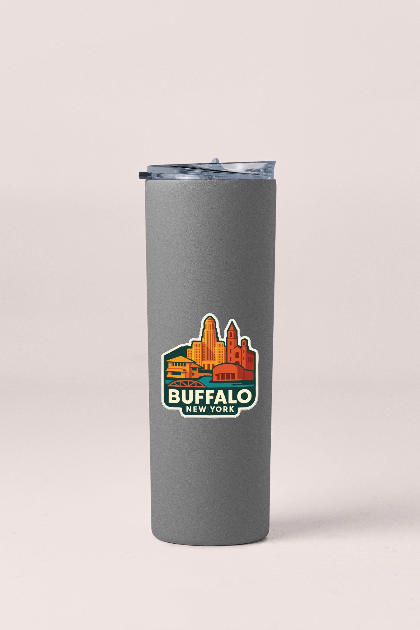 A gray insulated tumbler with a sticker depicting the city of Buffalo, New York.