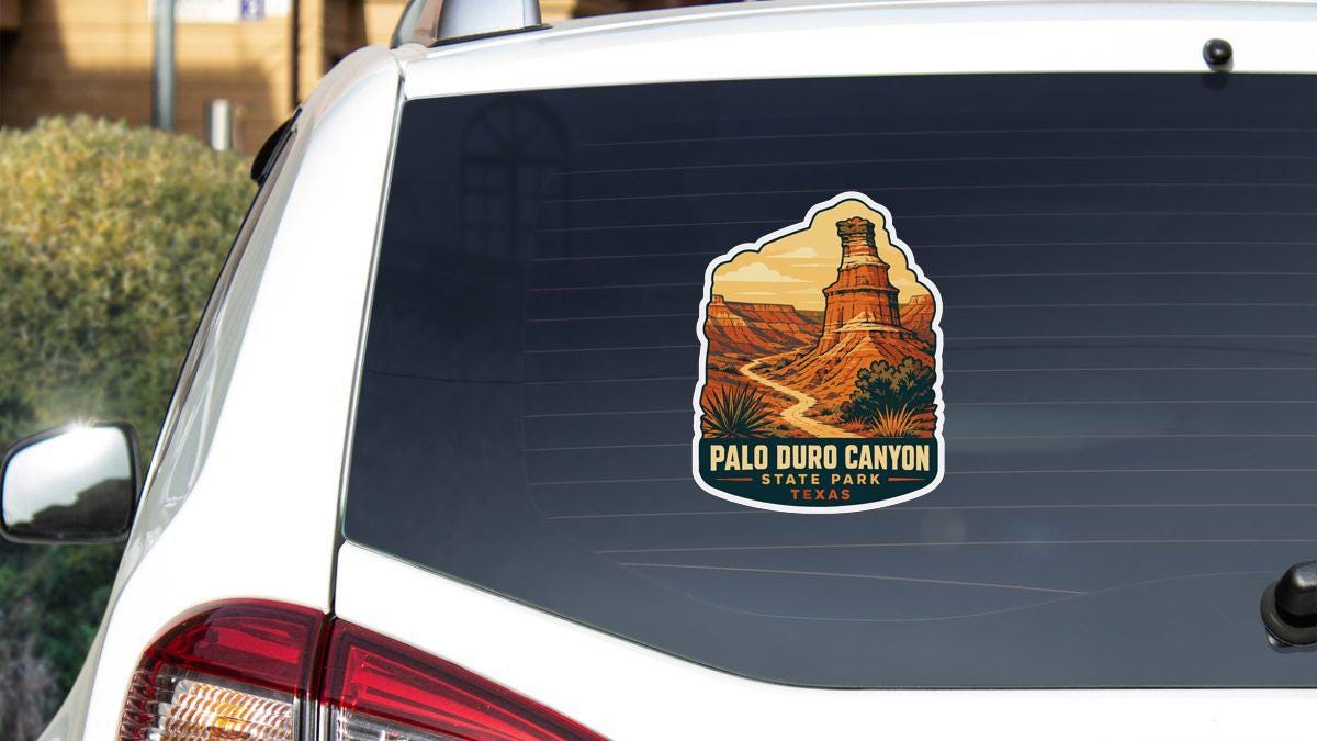 A sticker on the rear window of a white vehicle, depicting the iconic Palo Duro Canyon in Texas.