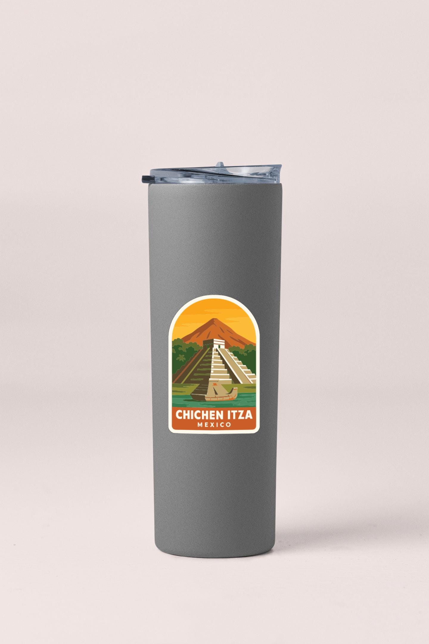 A gray insulated tumbler with a sticker depicting the Mayan ruins of Chichen Itza in Mexico.