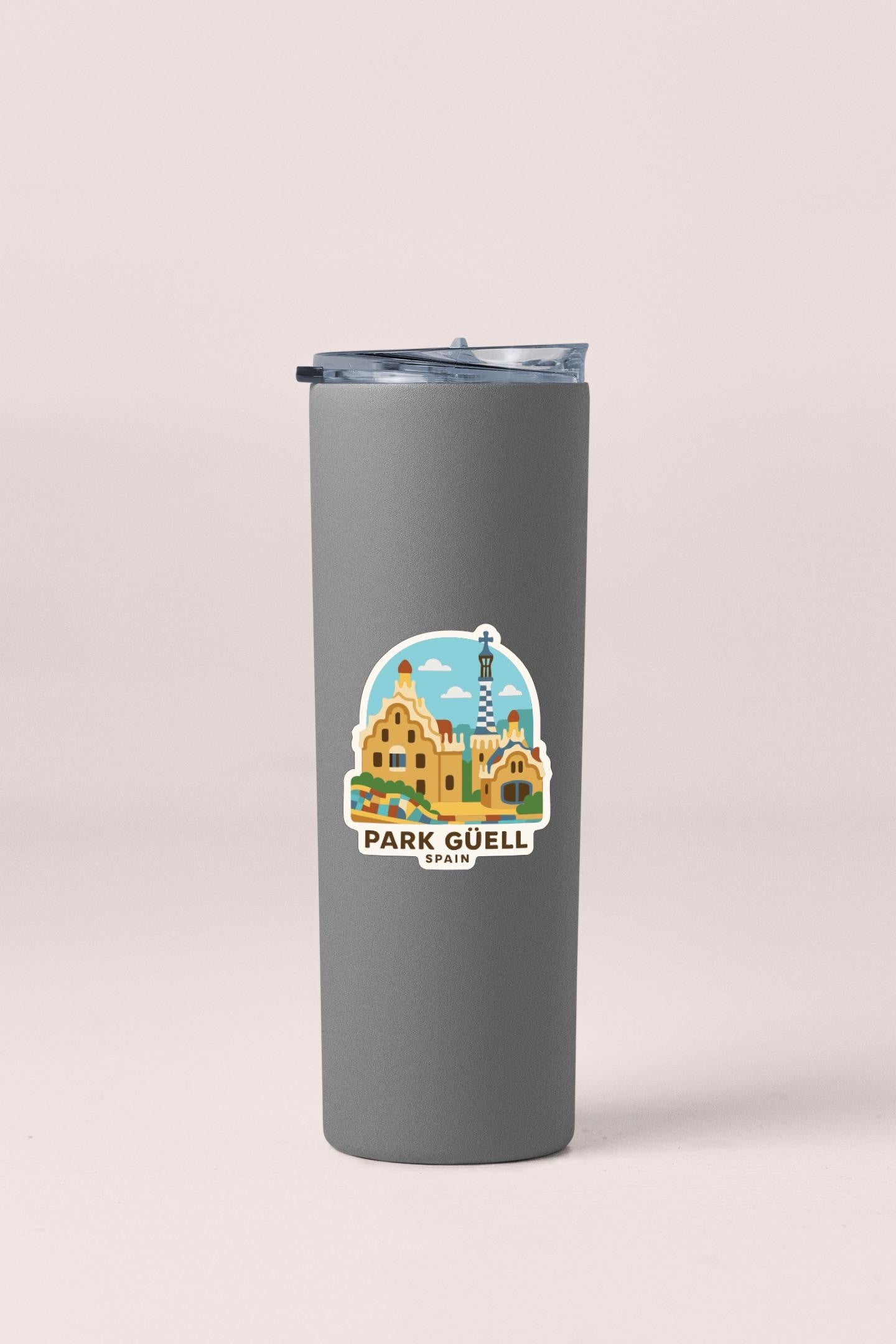 A gray tumbler with a sticker depicting the Park Güell in Spain.