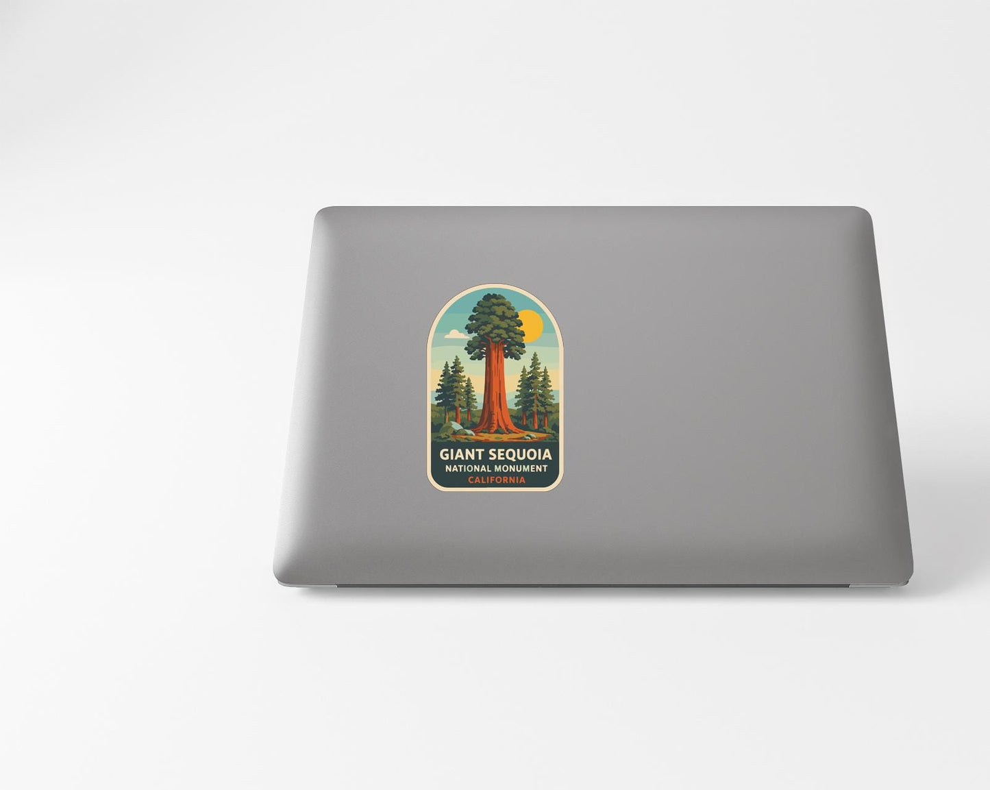 a sticker of a giant sequoia tree on a laptop.
