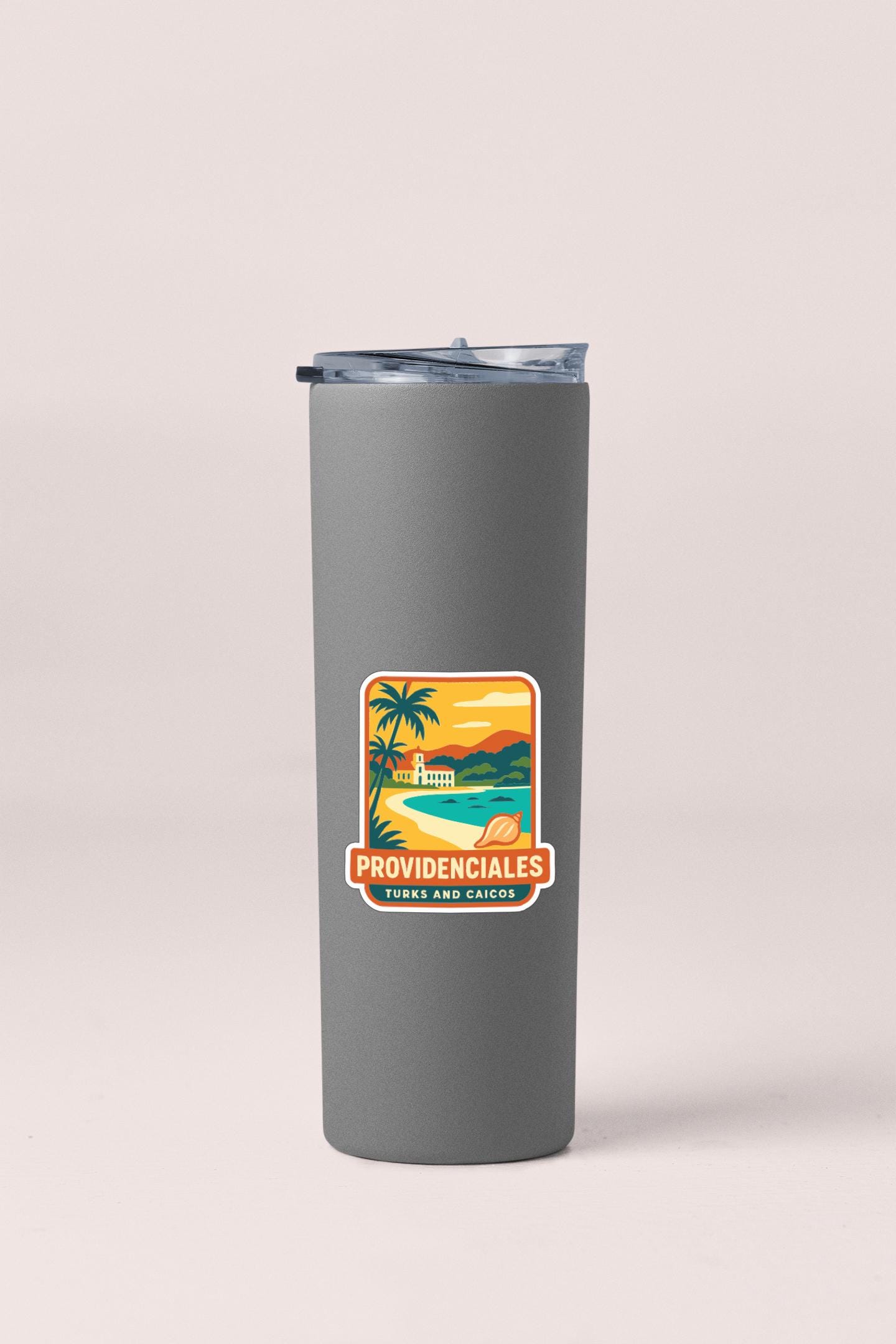 A gray insulated tumbler with a sticker depicting a tropical beach scene and the text "PROVIDENCIALES TURKS AND CAICOS".