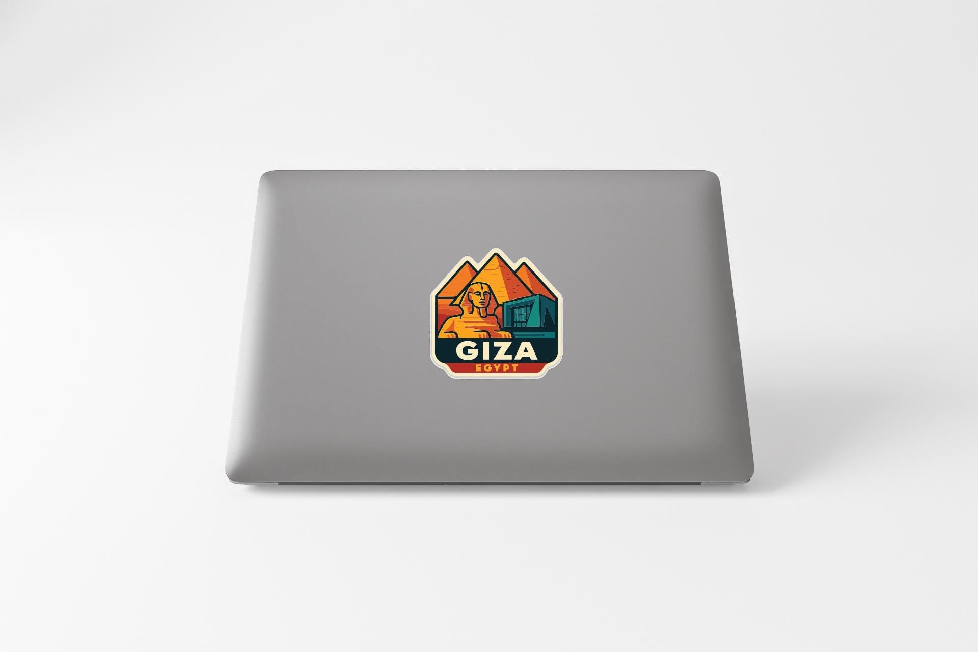 a sticker with a graphic of a person and the word "Giza" on the back of a laptop.