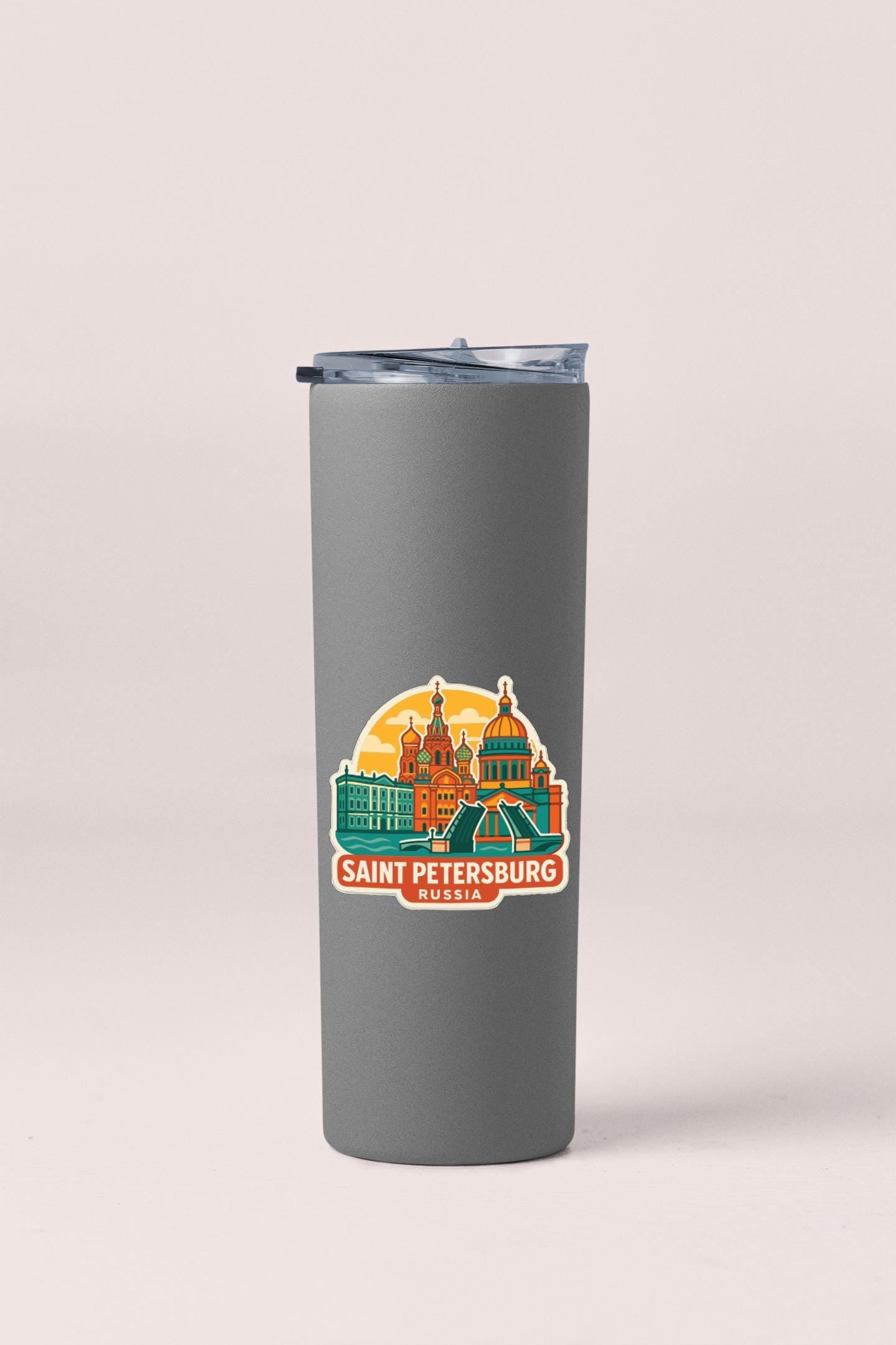 A gray insulated tumbler with a sticker depicting the Saint Petersburg skyline in Russia.