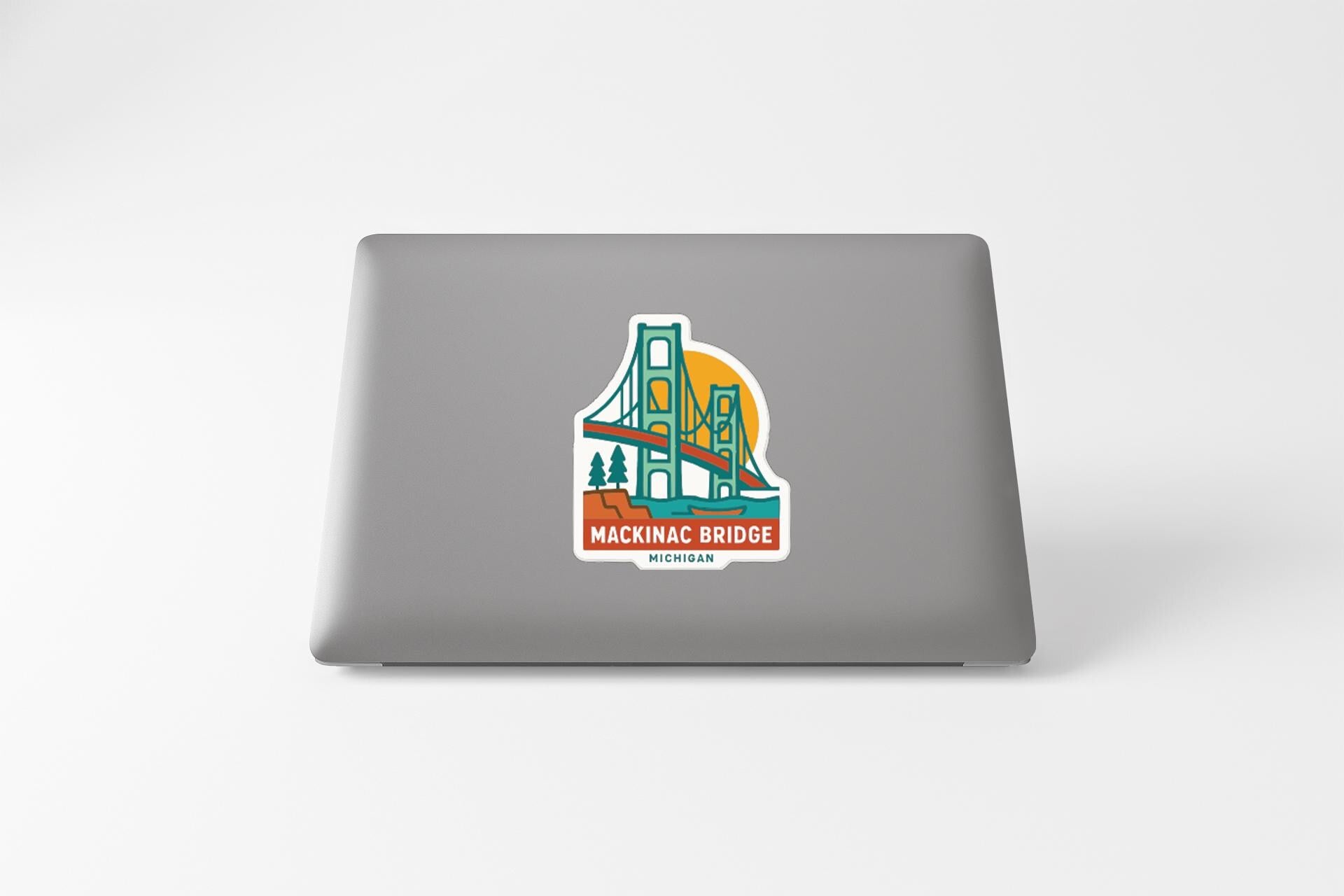 A sticker depicting the Mackinac Bridge on a laptop.