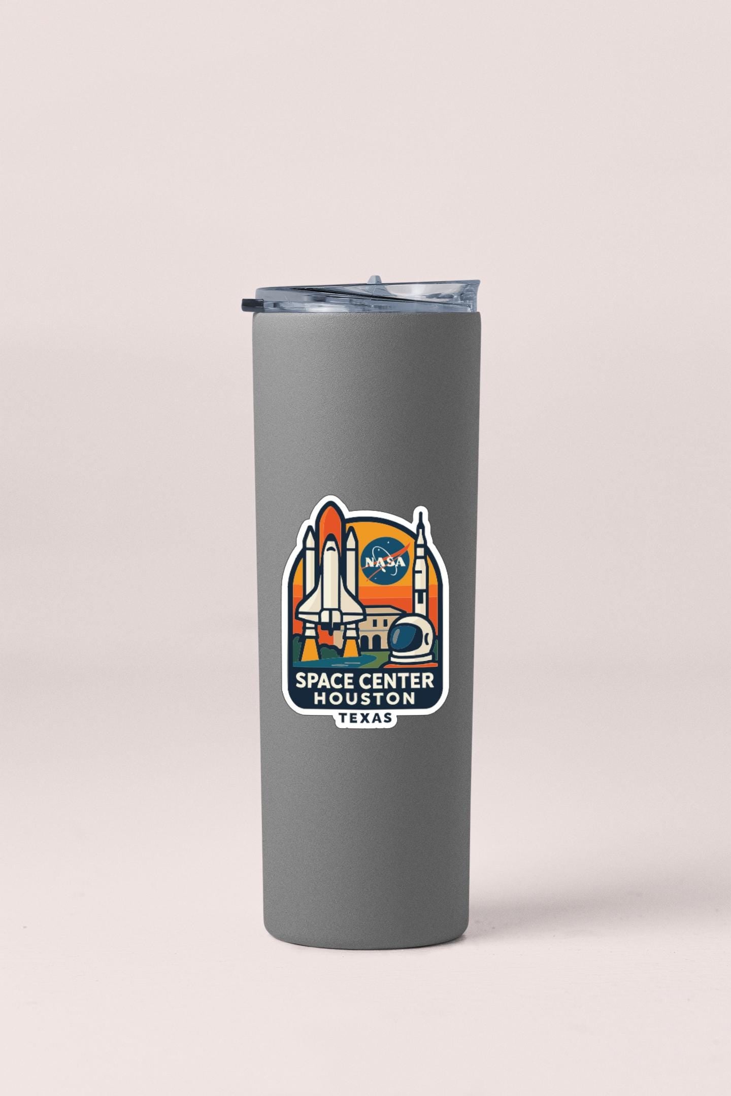 A gray tumbler with a NASA Space Center Houston, Texas logo printed on it.