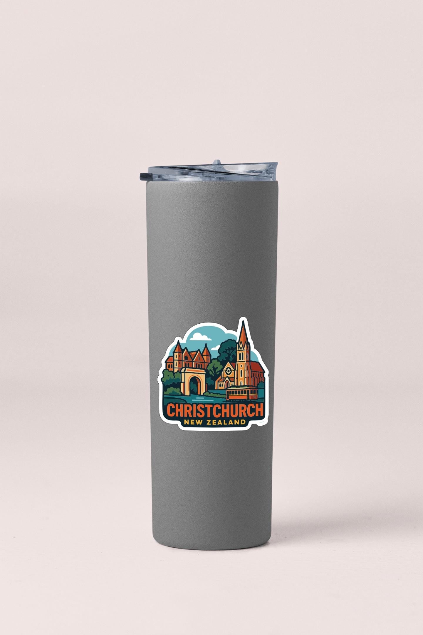 A gray insulated tumbler with a sticker depicting a cityscape and the text "Christchurch New Zealand" printed on it.