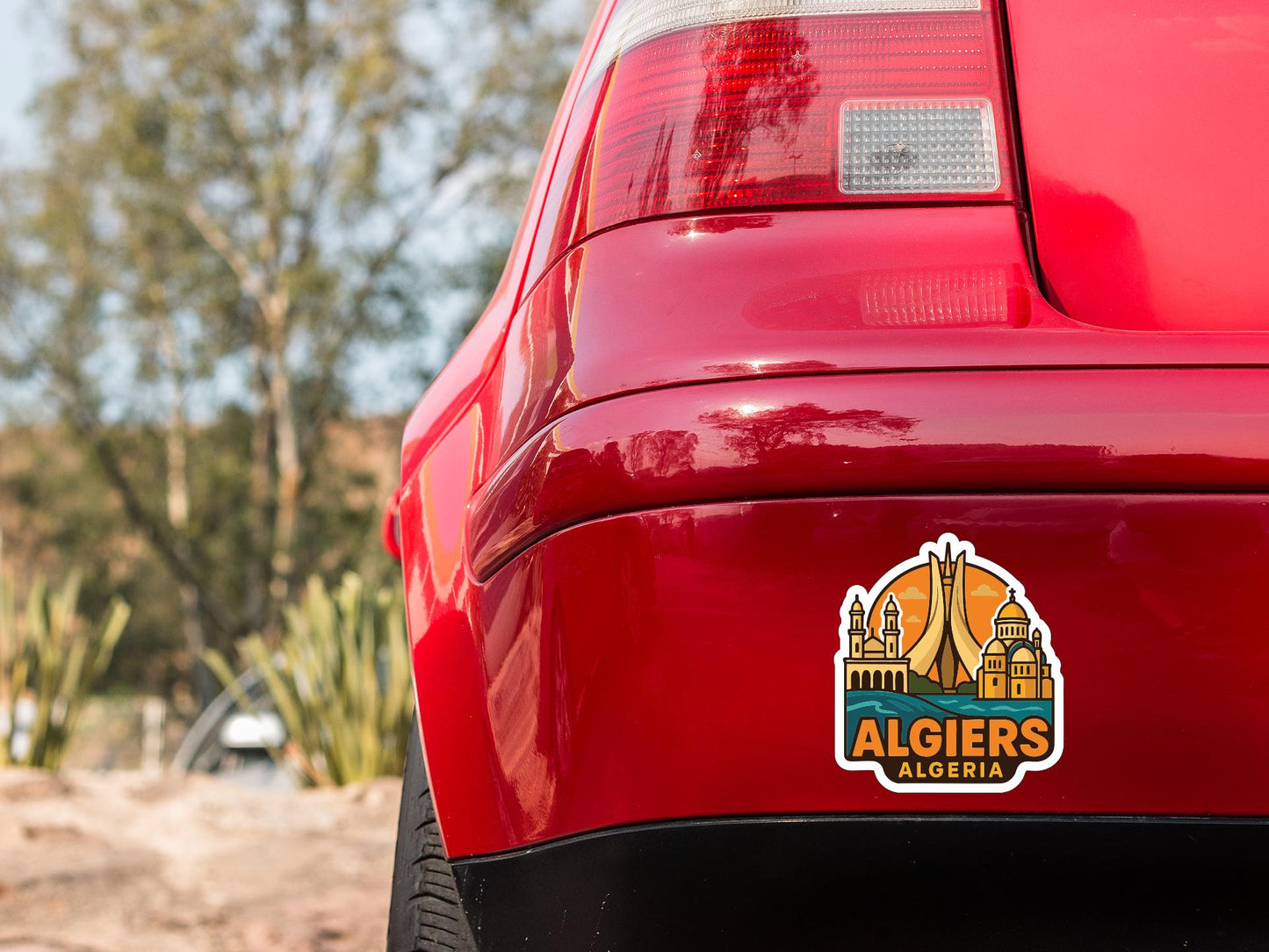 the rear end of a red car with a sticker on the trunk that says "ALGiers Algeria".
