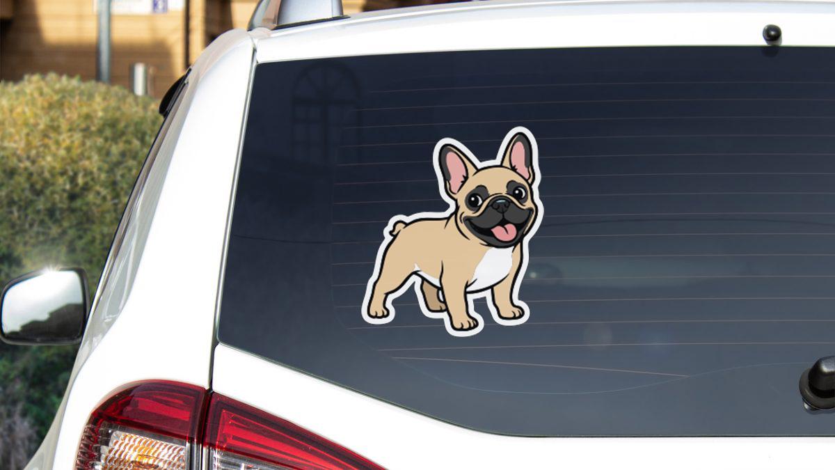a sticker of a dog on the rear window of a car.