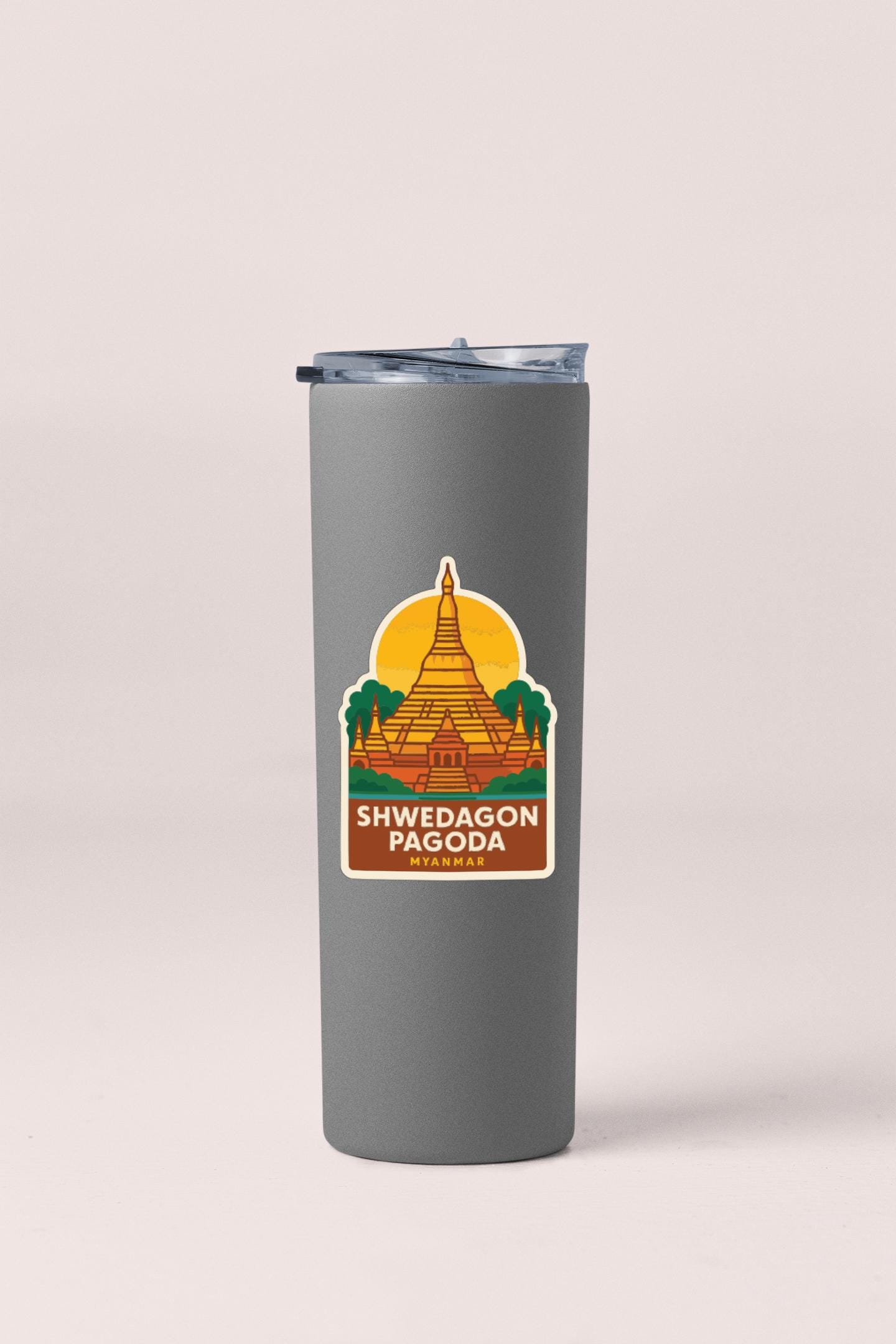 A gray insulated tumbler with a sticker depicting the Shwedagon Pagoda, a famous Buddhist temple in Yangon, Myanmar.
